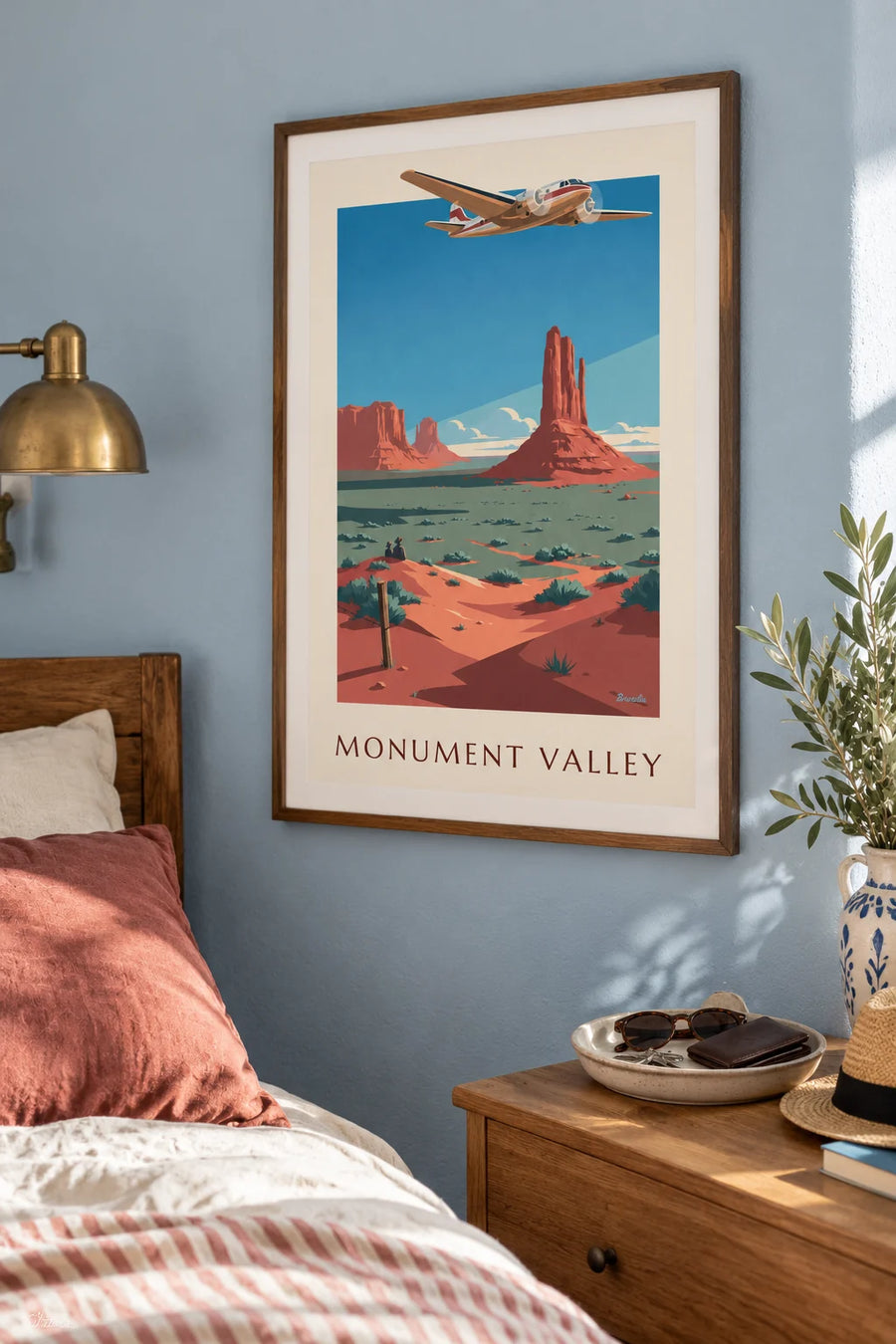Poster of a twin-engine airliner above Monument Valley: framed on the wall