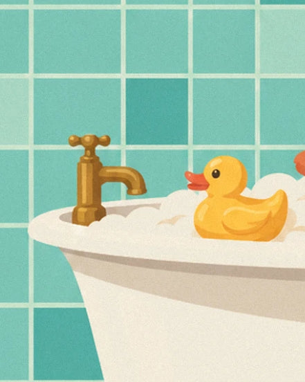 The yellow plastic duck beside the brass tap on the edge of the bath