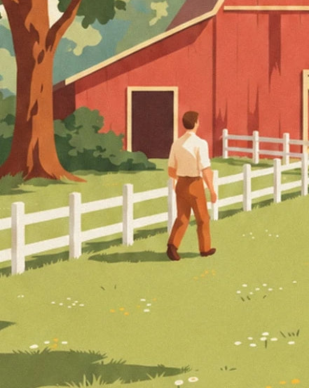 A man in a light shirt walking along the white fence, beneath a large tree, in front of the red barn