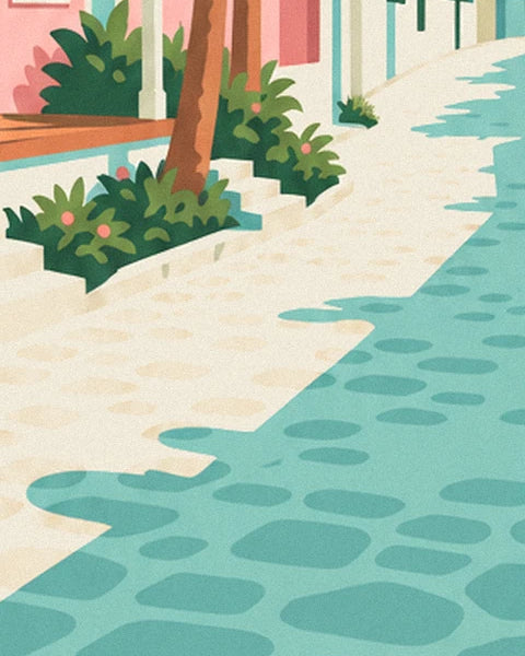 The lane of beige and turquoise cobbles running alongside the cottage, lined with flowering bushes