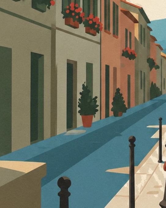 The lane with pastel façades, lined with potted plants and black bollards