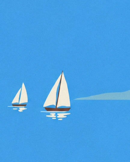 Les 2 voiliers aux voiles blanches sur une mer bleue, une île au loin