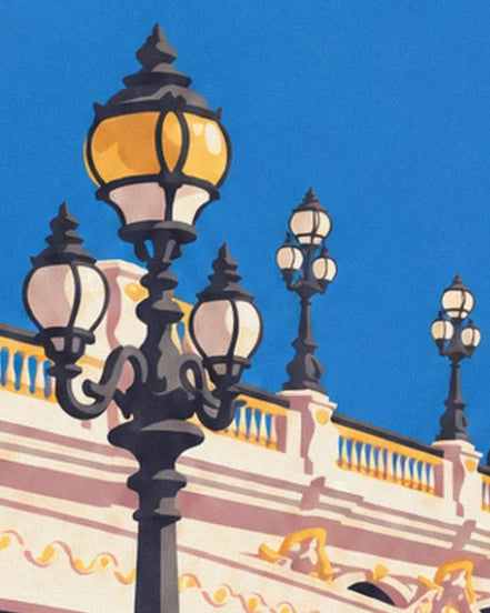 Black cast-iron street lamps with amber globes, against the bridge balustrade and blue sky