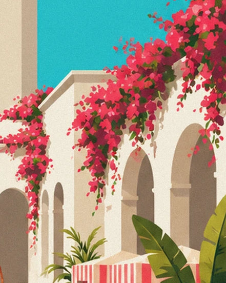 Pink bougainvillea cascading over the cream arches beneath the turquoise sky