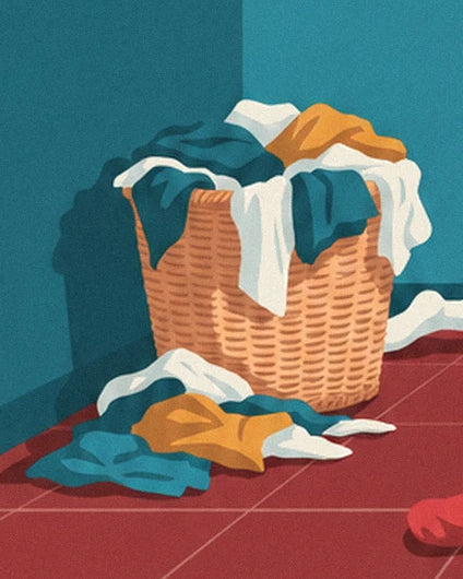 The wicker basket overflowing with white, blue and yellow laundry on the red tiles