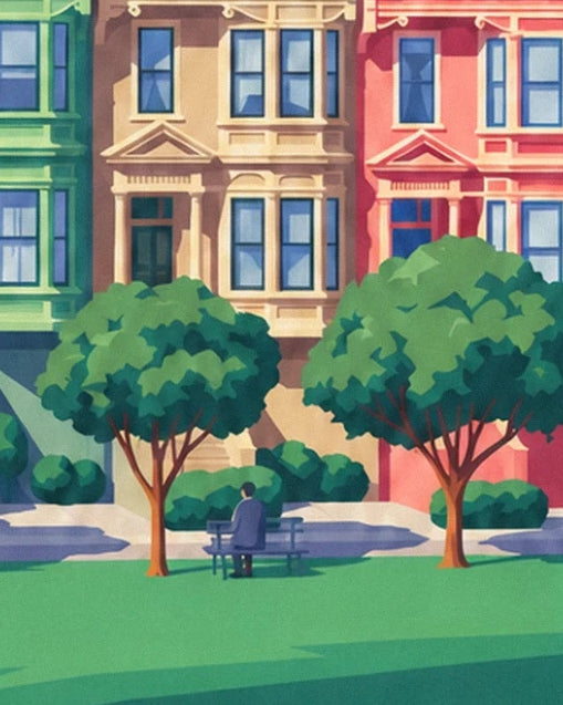 A man sitting on a bench between 2 round trees in front of beige and pink façades