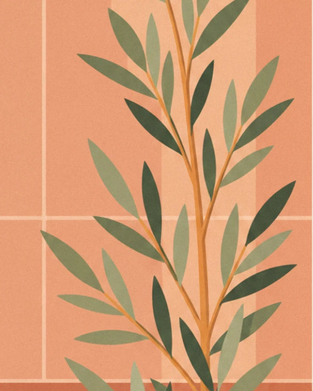 Une branche d'olivier aux feuilles vert sauge devant un mur de carreaux rose orangé