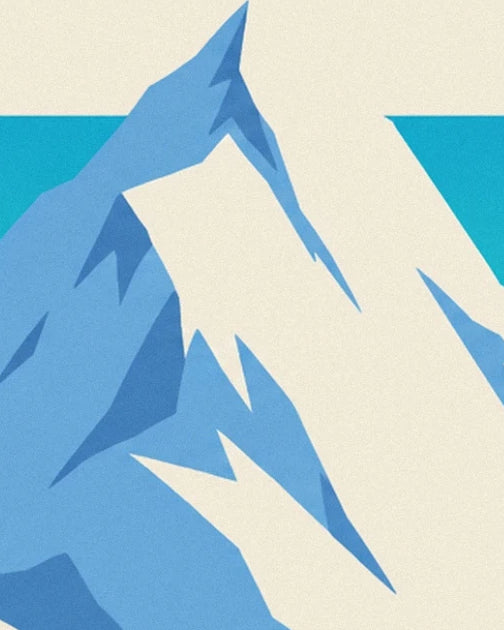 A snowy ridge with pale blue slopes and dark blue shadows