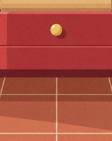 The red drawer with a gold knob in the kitchen dresser, above the terracotta floor tiles
