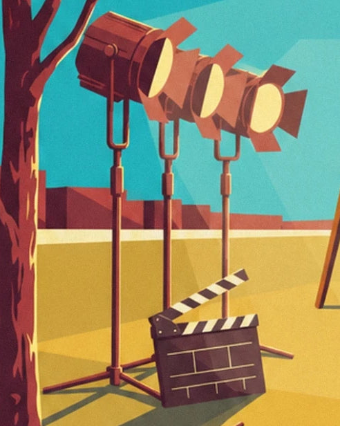 Les 3 projecteurs sur pied et un clap de cinéma ouvert sur le sol jaune du plateau