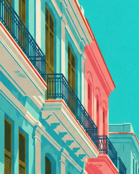 The blue wrought-iron balconies on a sunlit turquoise and pink façade
