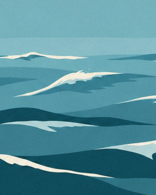 Turquoise waves crested with white foam on a sea of flat blue-green colours