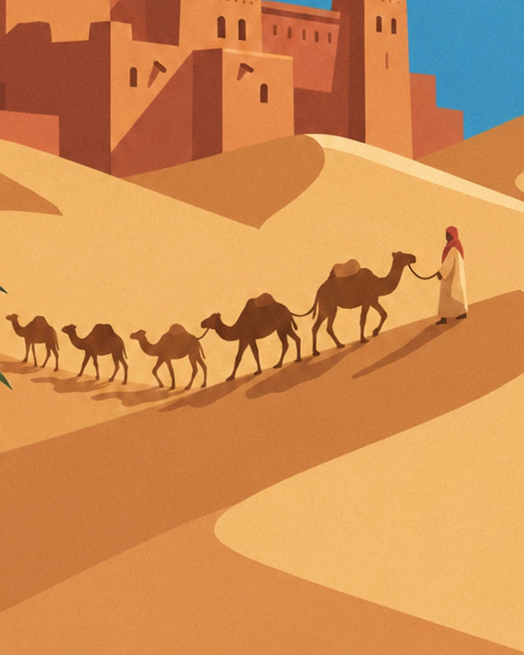 The camel driver in a white tunic and red turban leading his 5 camels across the golden dune