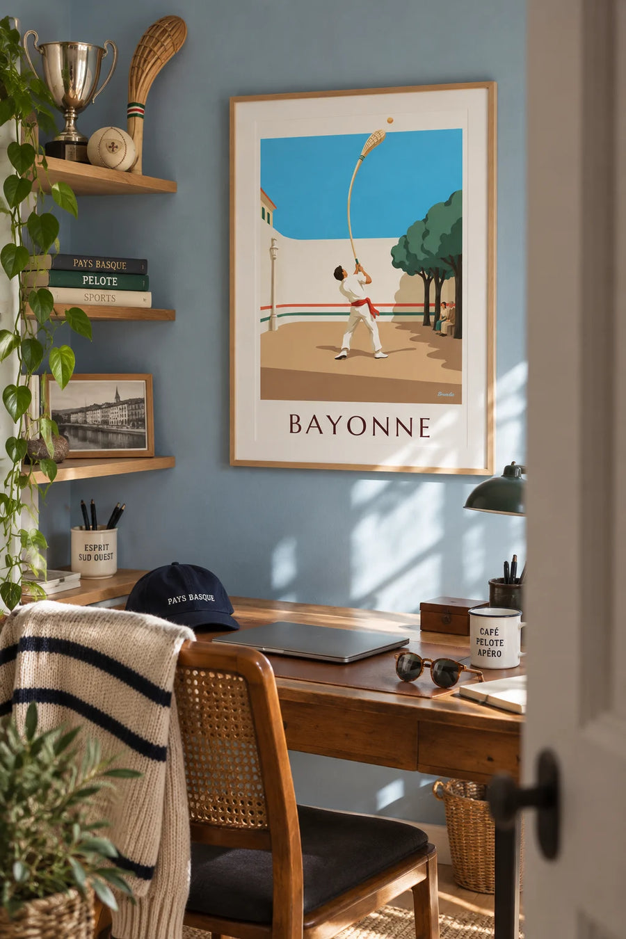 Poster of Basque pelota with a chistera in front of the Bayonne fronton: framed on a wall