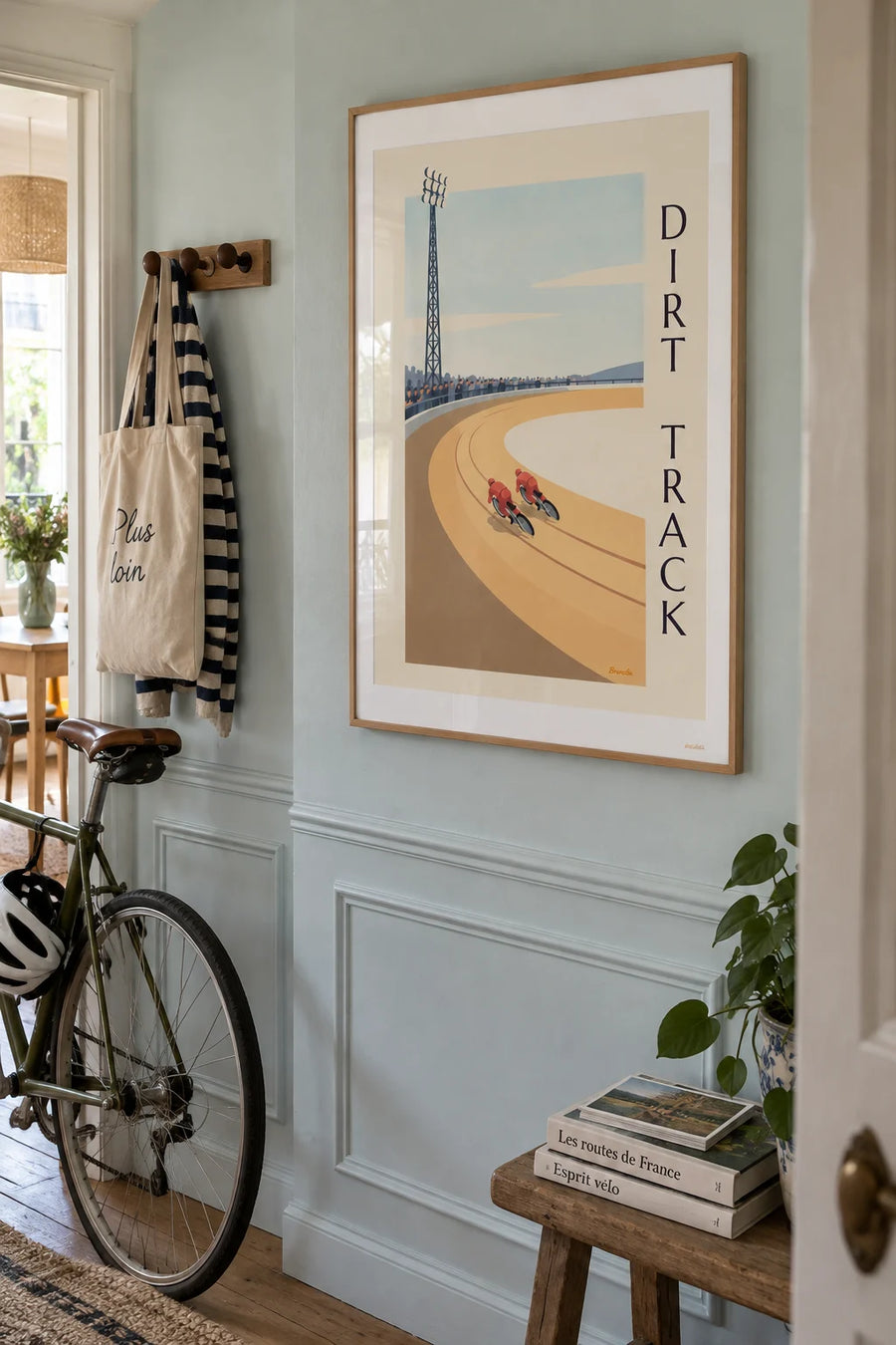 Poster of a speedway race on a dirt track: framed on a wall