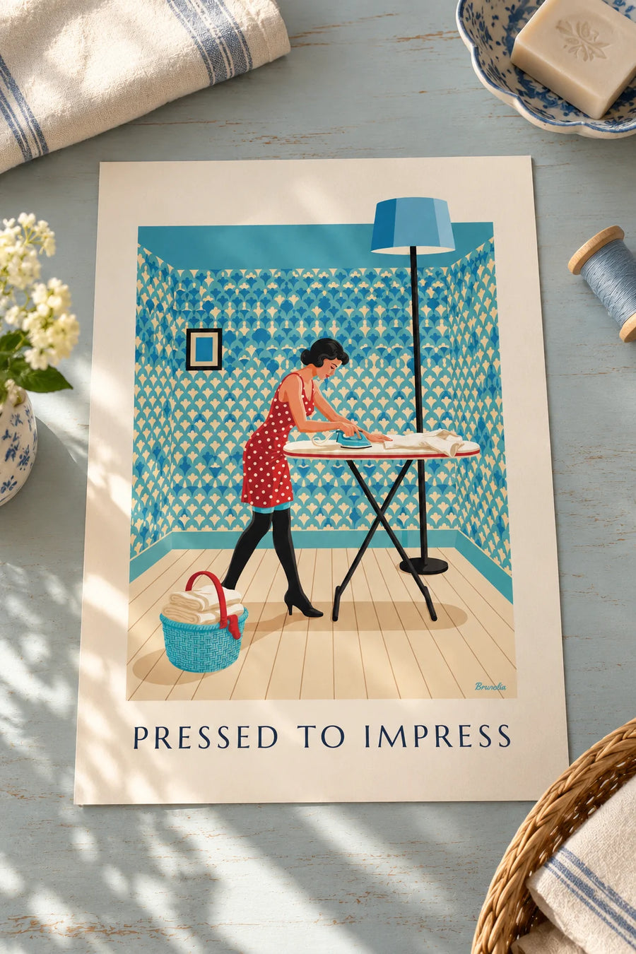 Poster of a pin-up ironing a shirt on her ironing board: set on a table